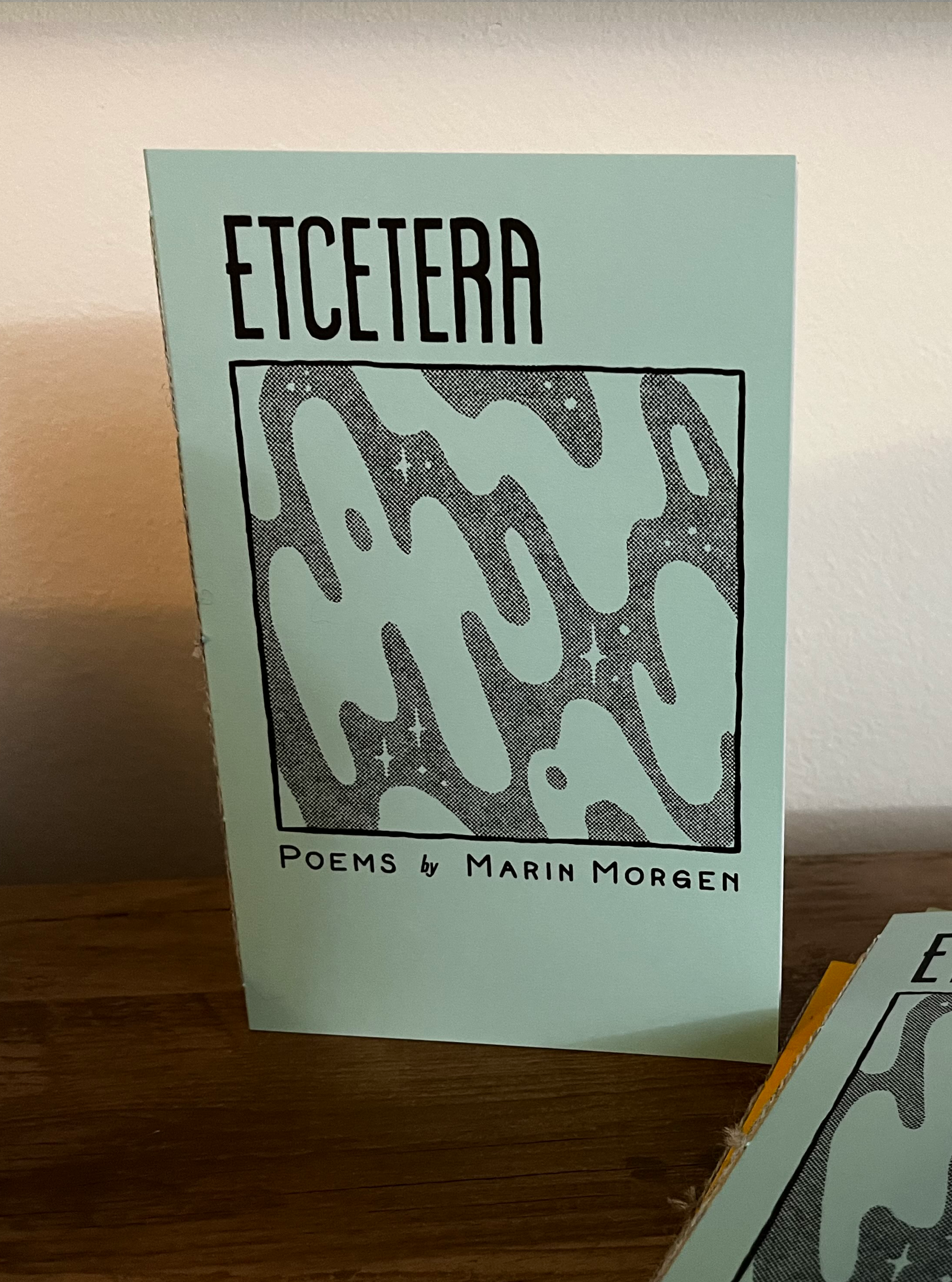 A zine titled Etcetera, with an illustration of stars in a swirling mist